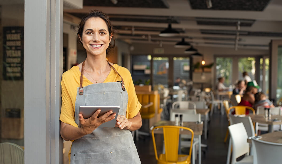 Female business owner holding a tablet.